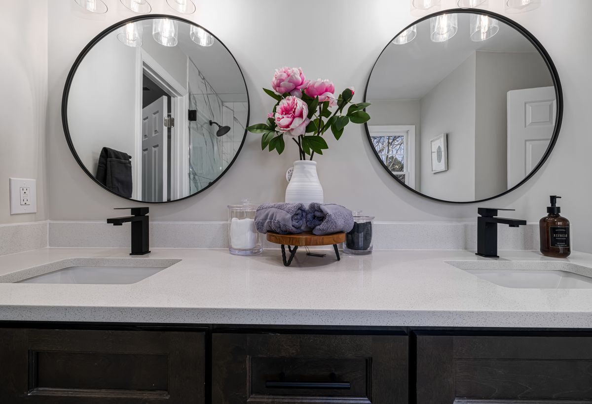 Bright contemporary vanity with round mirrors, representing the Lumina smart-mirror concept